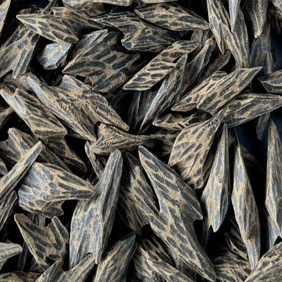 close up of the BASE notes ingredient, OUD which is used in the scented candle OUD
