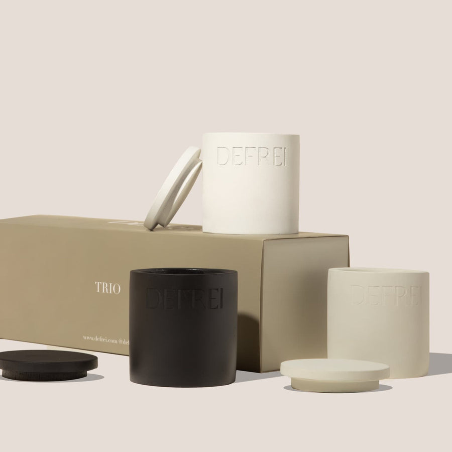 Sustainable packaging trio gift set of scented candles resting on top and next to the TRIO box GIFT SET box showing THORNN, BEDSHEETS and OUD