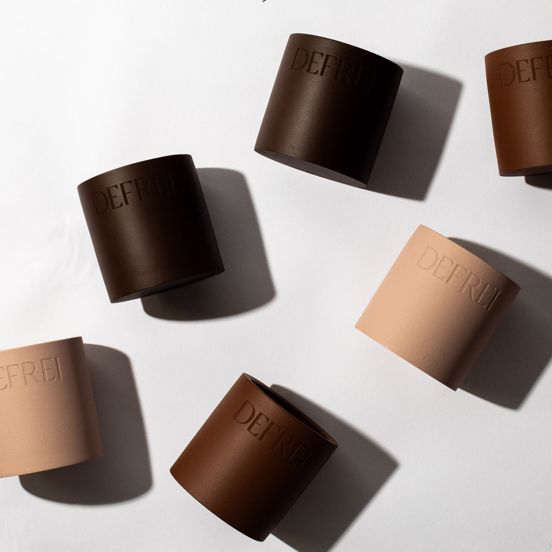 DEFREI candle vessels, showing side view of the scented candles LOBBY, AMOR and VANNILE